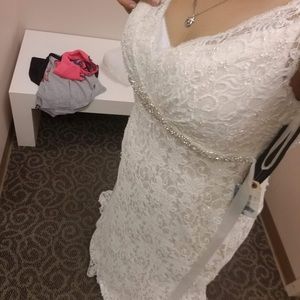 NEVER WORN OUTSIDE OF TRYING IT ON, brand new. Comes with slip and veil